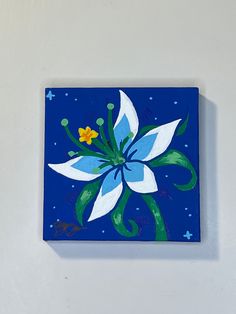 a blue and white flower painted on a wall