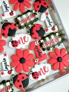 decorated cookies in the shape of flowers and ladybugs