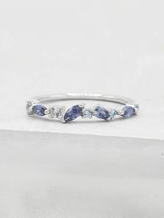 a white gold ring with blue sapphires and diamonds