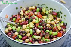 a white bowl filled with beans and veggies