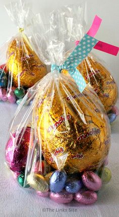 three bags filled with chocolate eggs on top of a table