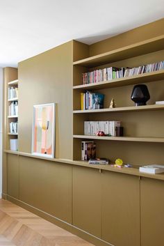 a living room filled with furniture and bookshelves