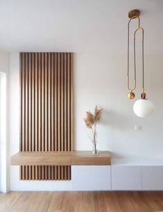 an empty room with wood paneling and white walls