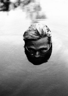 a man is submerged in the water with his head above the water's surface