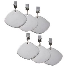 four metal tags with clippings attached to each one on a white background, set of five