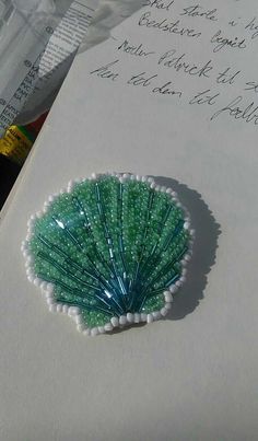 a close up of a piece of paper with writing on it and an image of a sea urchin