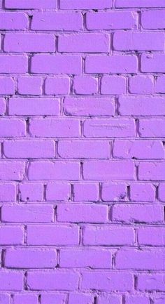 a purple brick wall is shown in this image