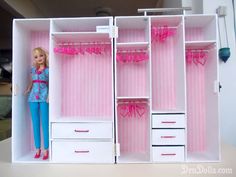 a barbie doll standing in front of a pink and white closet