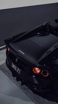 the rear end of a black sports car