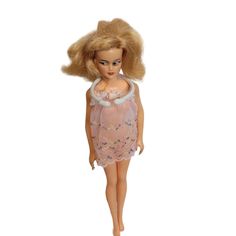 a doll with blonde hair wearing a pink dress