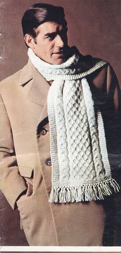 an old photo of a man wearing a knitted scarf with fringes on it