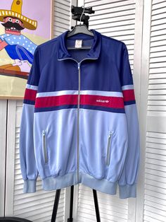 SIGN UP FOR MY STORE FOR DAILY UPDATES AND PRICE REDUCTIONS Follow us on Instagram @beton_vintage 10% off when buying 2 items 15% off when buying 3 items 20% off when buying 4 items Vintage Adidas Ventex Track Retro Jacket 90s West Germany  Size : M ❗️All our items are measured horizontally, the sizes are indicated on 3 photos. Material : 59% Polyester , 41% Cuprico Condition : 9/10 Jacket is in very good pre-owned condition Please check the photos carefully! Please ask all necessary questions before making a purchase. Shipping Information: Processing Time: We ship items within 2-5 business days after payment is received. Shipping Method: All orders use standard international shipping. Tracking number will be provided once your item has been shipped. Estimated Delivery Time: Delivery time Vintage Street Style, Adidas Vintage, Retro Jacket, Nike Windbreaker, West Germany, Vintage Adidas, Adidas Nike, Mens Outerwear, Light Jacket