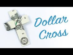 a dollar bill laying on top of a cross with the words dollar cross written across it