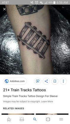 a black and white photo of a train track tattoo on someone's arm with the words, 21 + train tracks tattoos