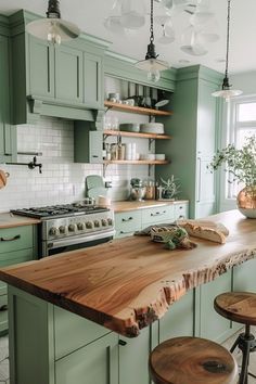 a kitchen with green cabinets and wooden counter tops, two stools in front of the island