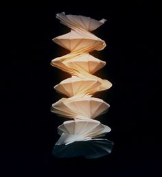 a stack of folded paper sitting on top of a table