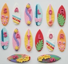 there are many decorated surfboards and letters on the board, all in different colors