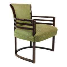 an upholstered arm chair with wooden frame and green fabric on the back, in front of a white background