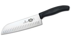 a large knife with a black handle on a white background