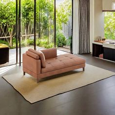 a living room filled with furniture and large windows