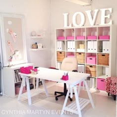 an image of a home office with pink and white furniture