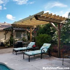 an outdoor living area with lounge chairs and a pergolated gazebo next to a swimming pool