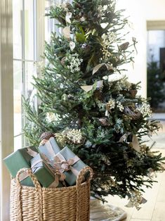 a christmas tree with presents in a wicker basket