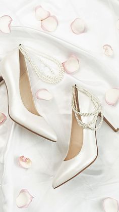 white high heel shoes with pearls on them