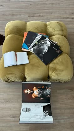 an overhead view of a couch with magazines on it and a book in the middle