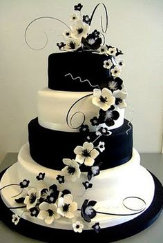 a three tiered wedding cake with white and blue flowers