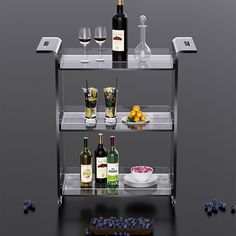 three shelves with wine bottles, plates and glasses on them in front of some grapes