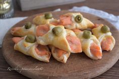 small appetizers are arranged on a wooden platter