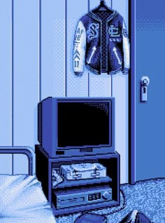 a room with a bed, television and jacket hanging on the wall next to it