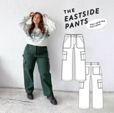 a woman standing in front of a wall with her hands on her head and wearing green pants