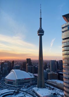 an aerial view of the cn tower and surrounding buildings in toronto, canada at sunset