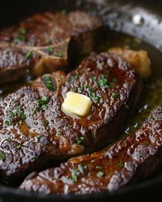 steak with butter and parsley in a skillet