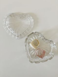 two heart shaped dishes sitting on top of a table