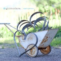 an old rusty wheelbarrow is sitting on the ground