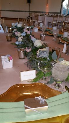 the table is set up with place settings and napkins for guests to sit at