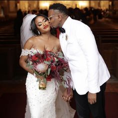 a bride and groom kissing in the church