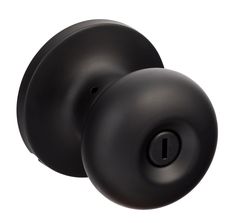 the door knob is black and has a round handle