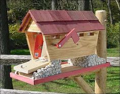 a bird house made out of wood and rocks