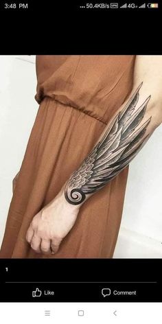 a woman's arm with an angel tattoo on the left side of her arm