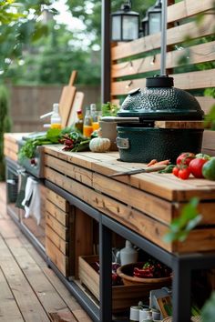 an outdoor bbq grill with vegetables and fruit on the counter top, surrounded by greenery