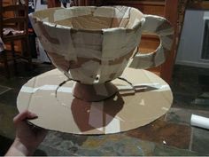 someone is making a cup out of cardboard