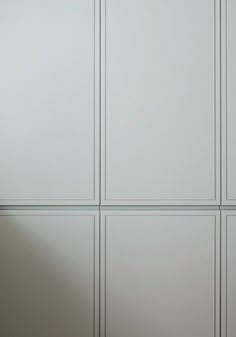 an empty room with white walls and cupboards