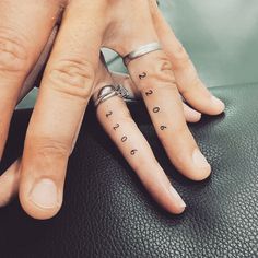 two people with matching tattoos on their fingers