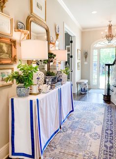 a table with blue and white decorations on top of it in front of a doorway