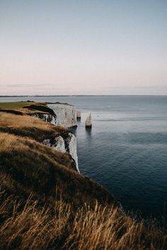 an image of the ocean and cliffs that are white