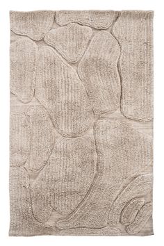 a beige rug with an abstract design on the front and back side, it is made from